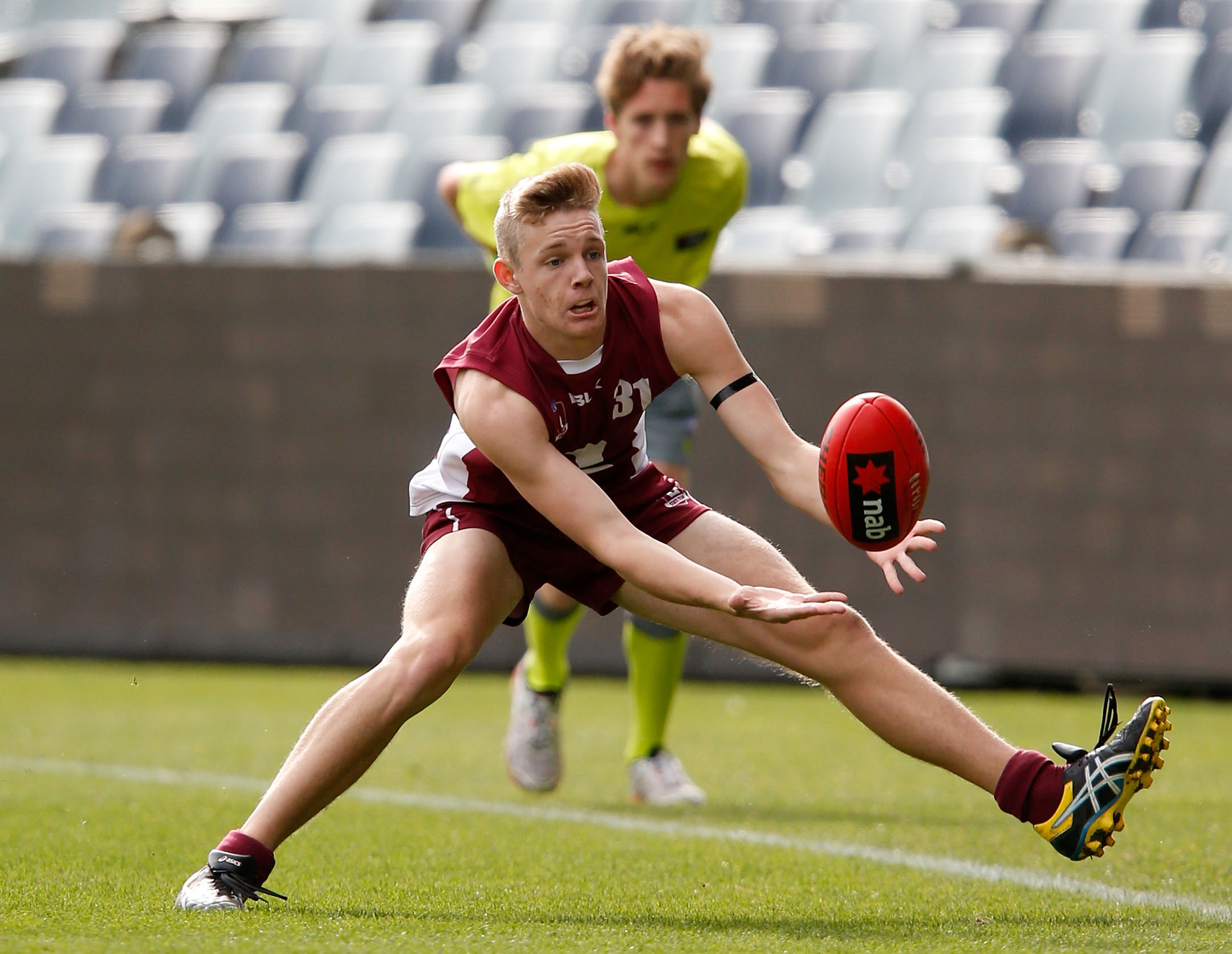 GEELONG, AUSTRALIA - JUNE 27: Max Spencer of Queensland gathers the ball during the 2015 AFL Under 18 match between Queensland and Tasmania at Simonds Stadium, Geelong on June 27, 2015. (Photo by Darrian Traynor/AFL Media)